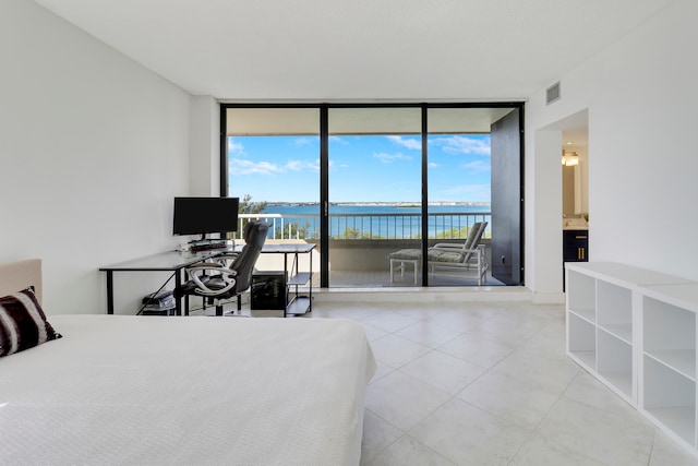 bedroom with expansive windows, access to exterior, and multiple windows