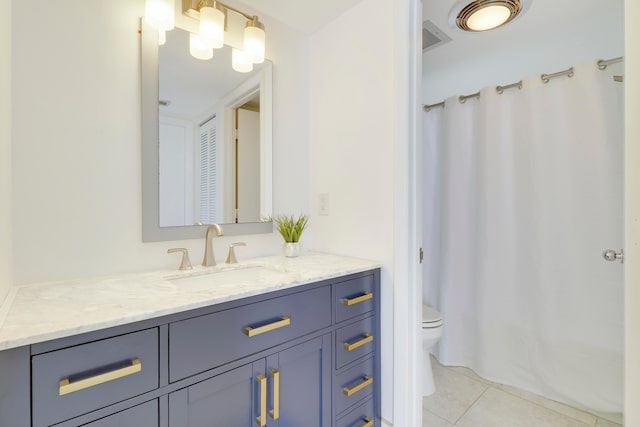 bathroom featuring tile patterned floors, vanity, and toilet