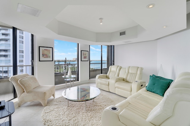 tiled living room featuring a water view