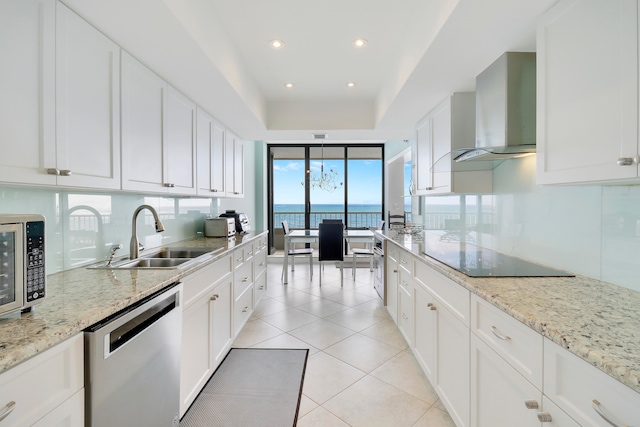 kitchen featuring white cabinets, sink, a water view, and appliances with stainless steel finishes