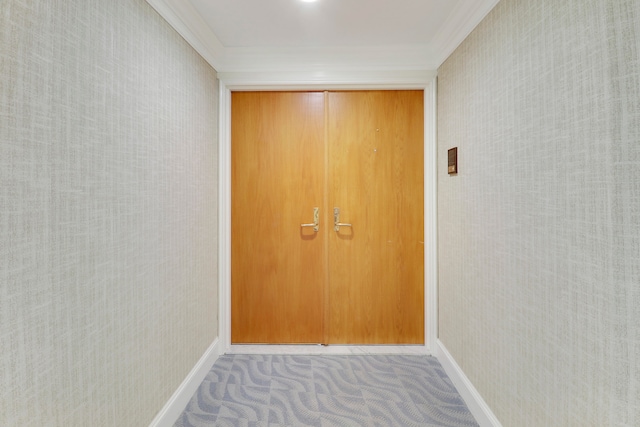 entryway featuring light carpet and ornamental molding