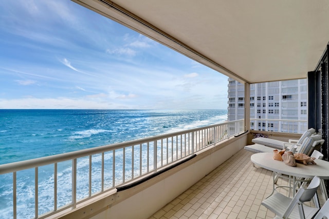 balcony with a view of the beach and a water view