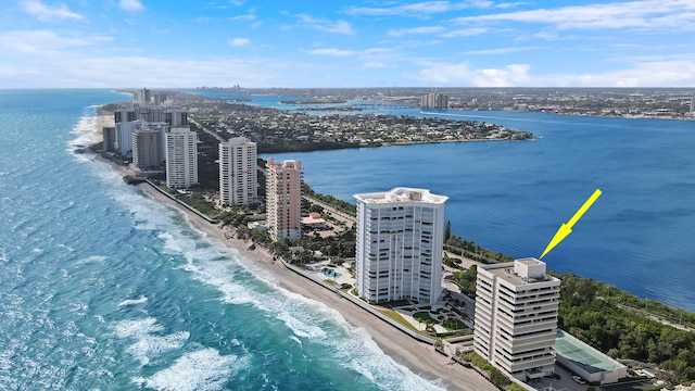 bird's eye view featuring a water view and a beach view