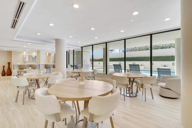 dining area with light hardwood / wood-style flooring and floor to ceiling windows