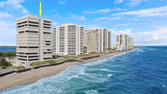 view of property featuring a water view and a beach view