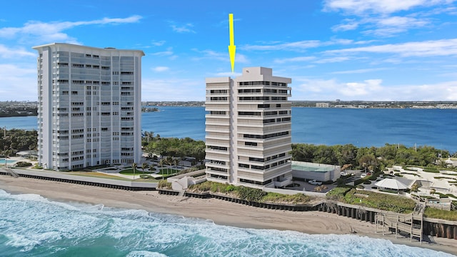 view of building exterior with a view of the beach and a water view