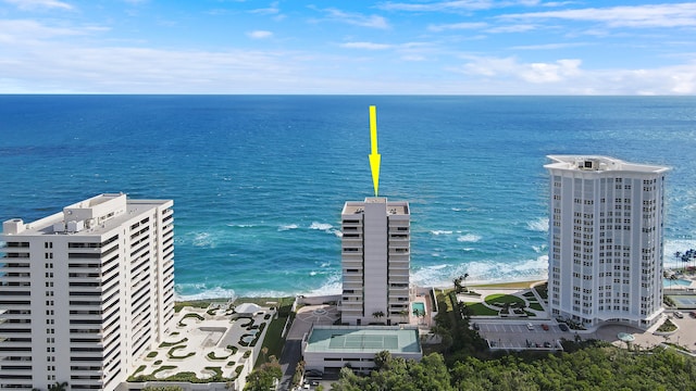 birds eye view of property with a water view and a view of the beach