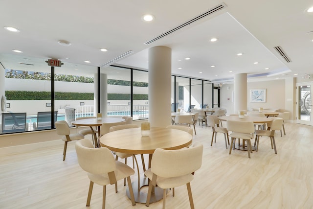 dining space with light hardwood / wood-style floors