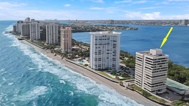 birds eye view of property featuring a water view and a beach view