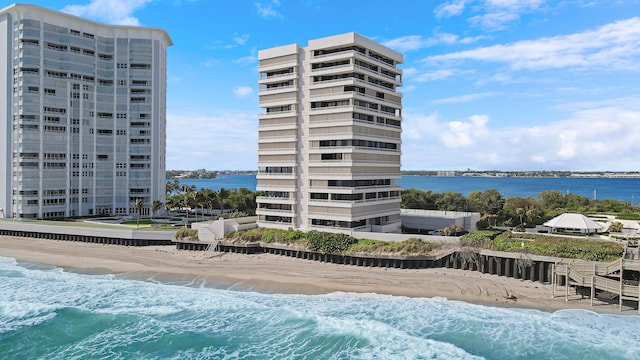 exterior space featuring a water view and a beach view