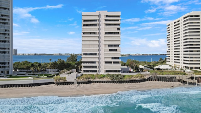 view of swimming pool with a view of the beach and a water view