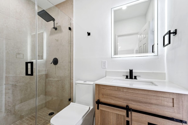 bathroom featuring vanity, an enclosed shower, and toilet