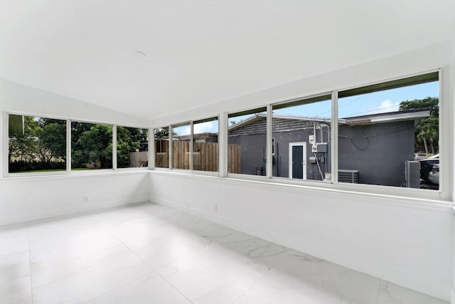 unfurnished sunroom with lofted ceiling