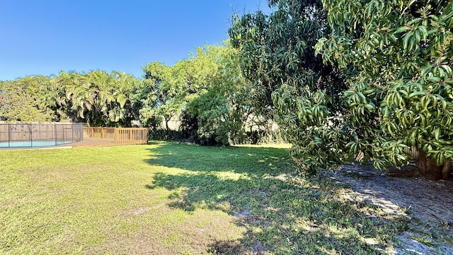 view of yard with a fenced in pool