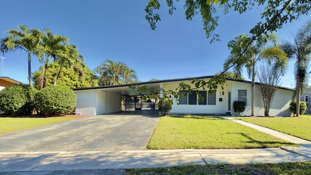 ranch-style home featuring a front yard and a carport