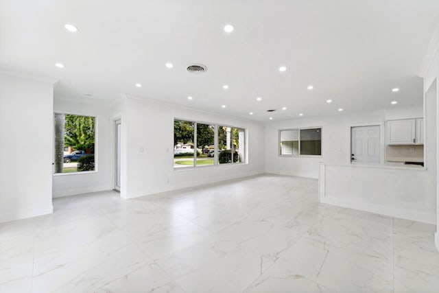 unfurnished living room featuring ornamental molding