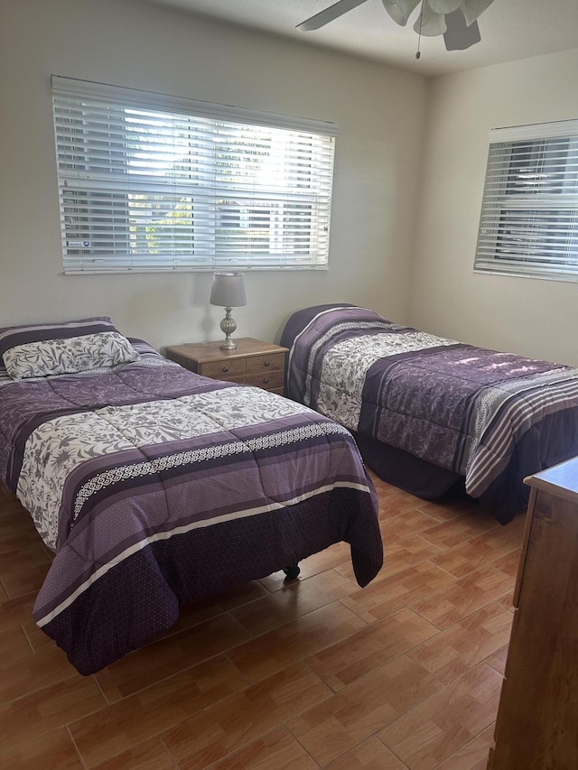 bedroom with a ceiling fan and wood finished floors