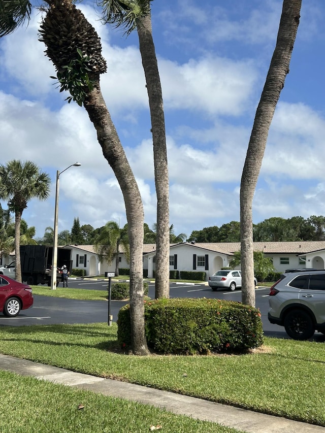 view of street featuring sidewalks, street lighting, and a residential view