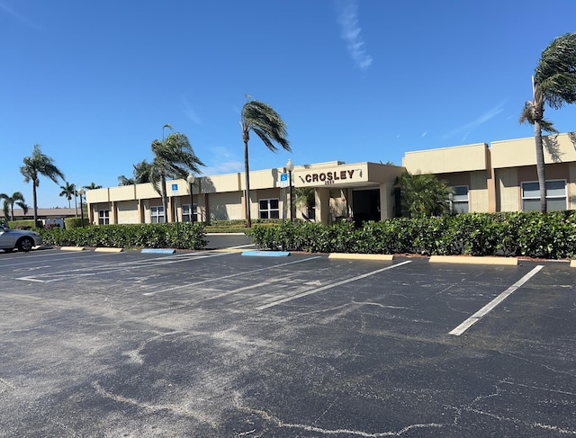 view of building exterior with uncovered parking