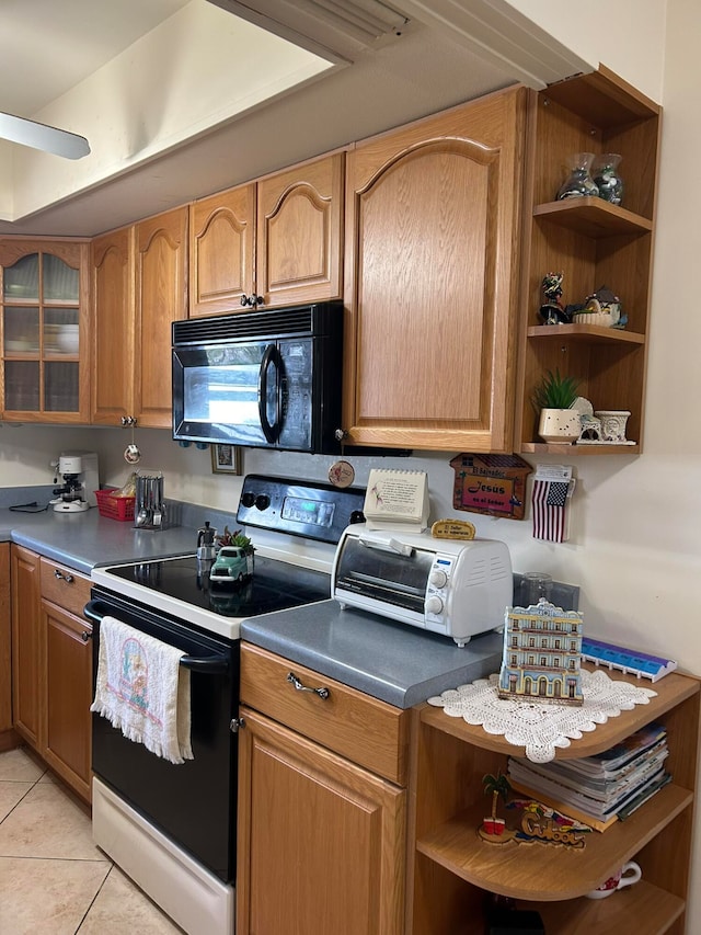 kitchen with white electric stove and light tile patterned floors