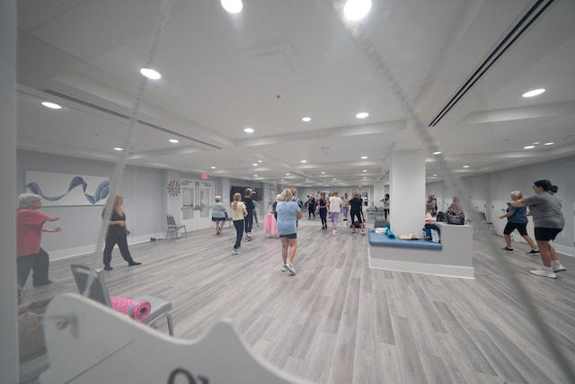 exercise room featuring light wood-type flooring