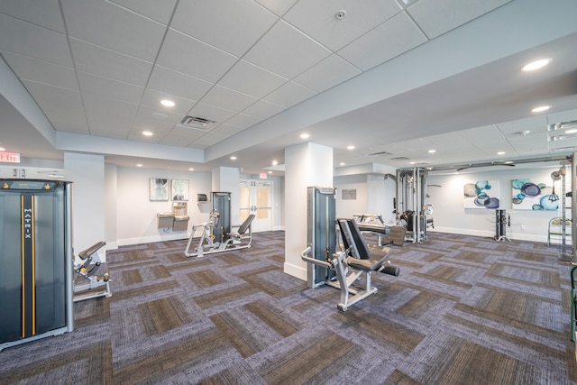 exercise room with a drop ceiling and dark carpet