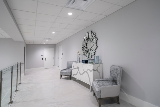 sitting room with a drop ceiling