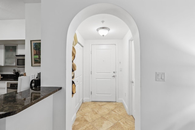 doorway to outside with light tile patterned flooring