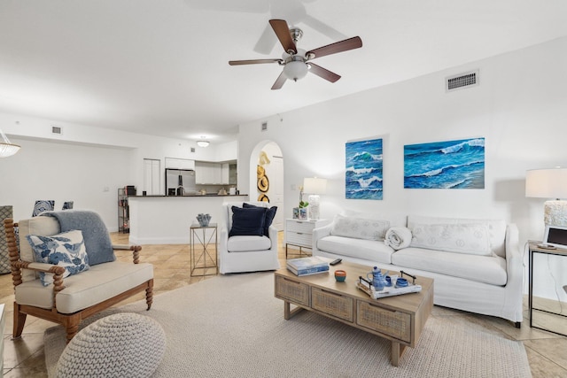 tiled living room featuring ceiling fan