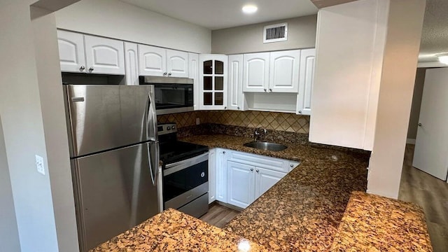 kitchen with sink, appliances with stainless steel finishes, and white cabinets