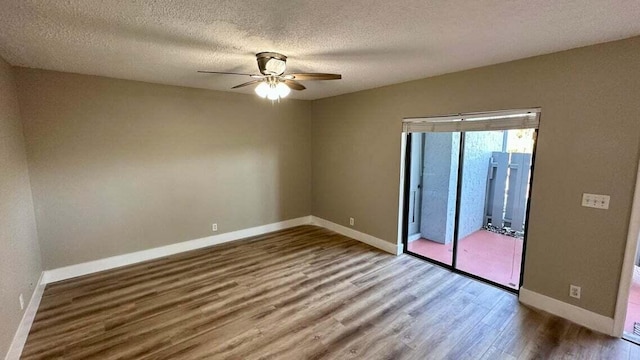 empty room with hardwood / wood-style floors, a textured ceiling, and ceiling fan