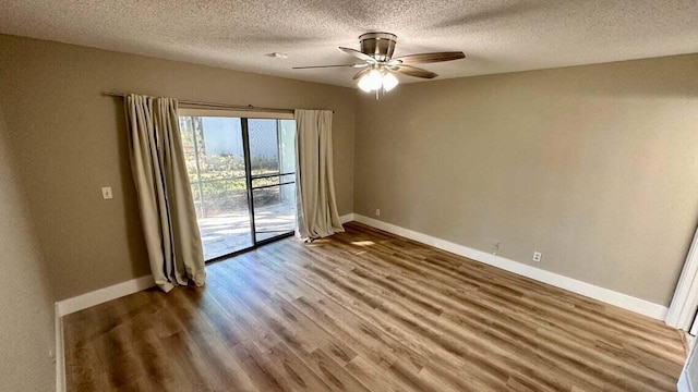 spare room with ceiling fan, a textured ceiling, and hardwood / wood-style floors