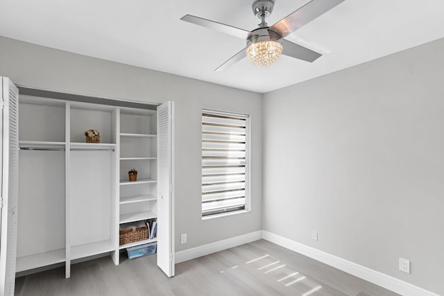 unfurnished bedroom with ceiling fan, light hardwood / wood-style floors, and a closet