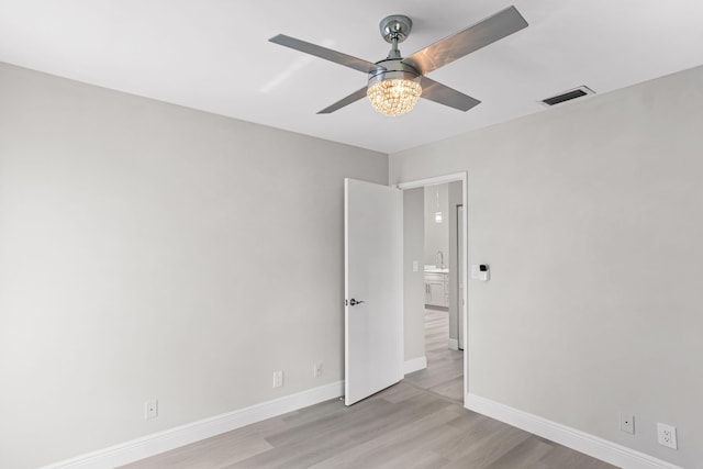 unfurnished room with ceiling fan and light hardwood / wood-style flooring