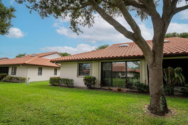 rear view of house with a lawn