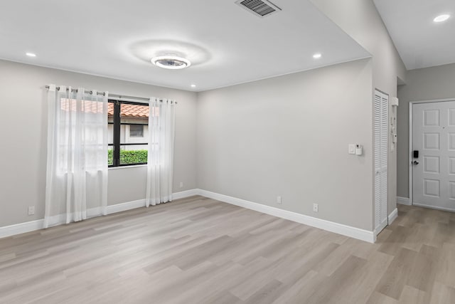 empty room with light hardwood / wood-style flooring