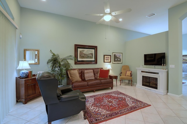 living room featuring ceiling fan, light tile patterned floors, and high vaulted ceiling