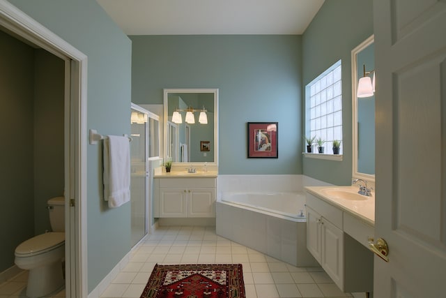 full bathroom with tile patterned flooring, vanity, toilet, and independent shower and bath