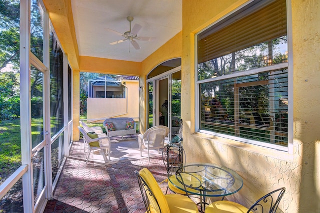 sunroom featuring ceiling fan