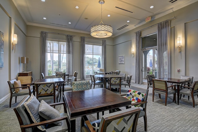 dining area featuring light colored carpet and crown molding