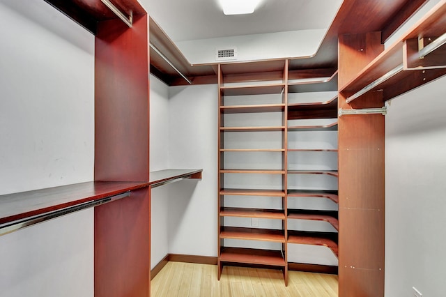 spacious closet with light hardwood / wood-style flooring