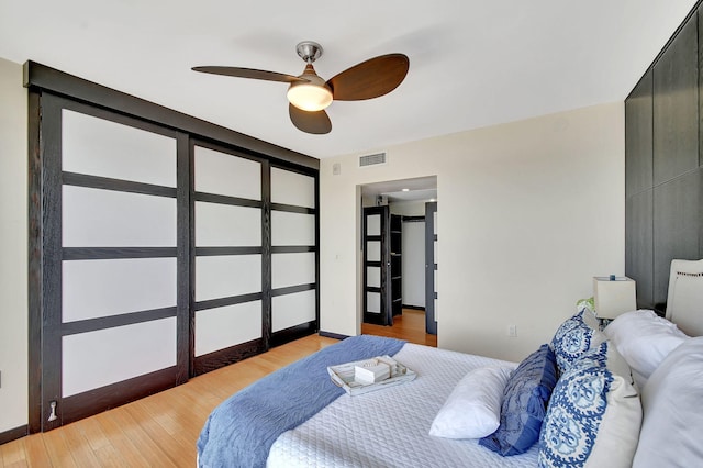 bedroom with ceiling fan and light hardwood / wood-style floors