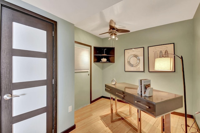 home office with ceiling fan and light hardwood / wood-style flooring