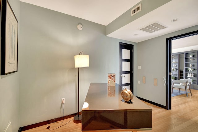 office area with light hardwood / wood-style floors