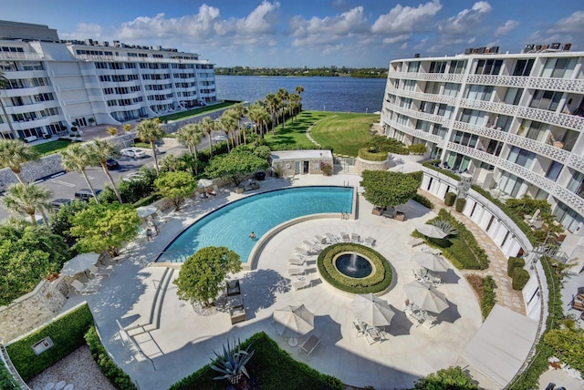 view of pool with a water view and a patio