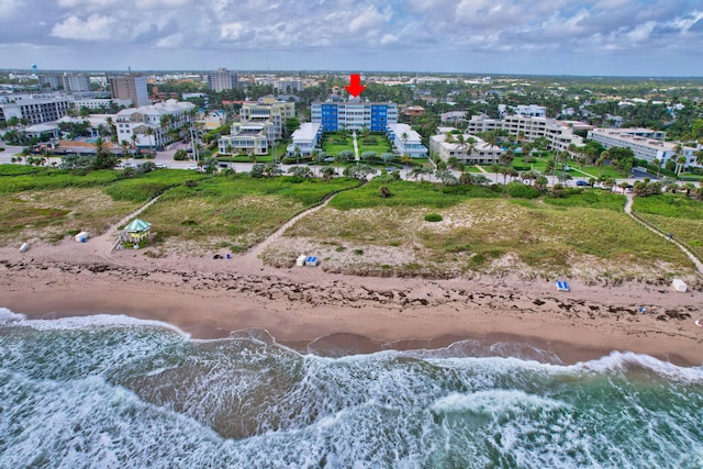 birds eye view of property featuring a beach view and a water view