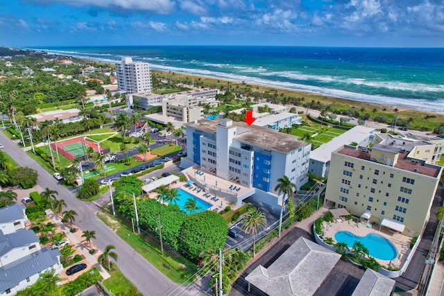 bird's eye view featuring a water view and a beach view