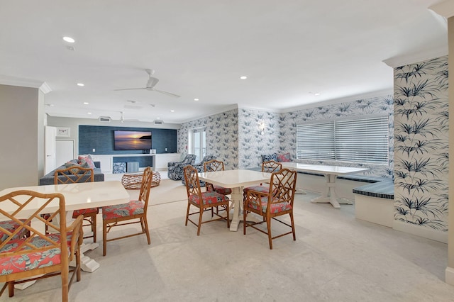 dining area with ceiling fan and crown molding