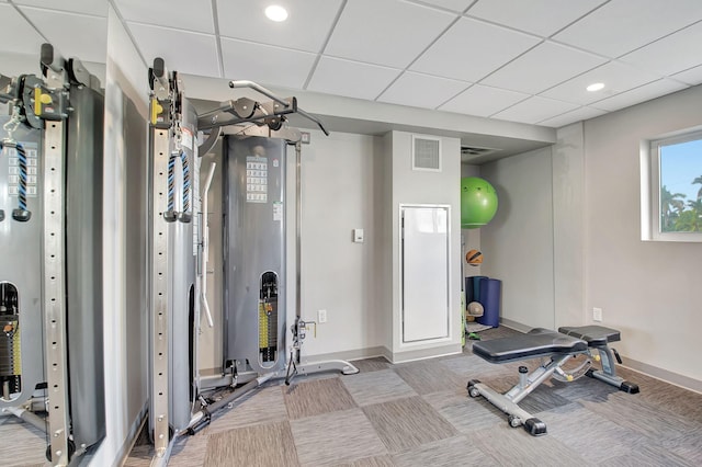 workout area featuring a drop ceiling and carpet