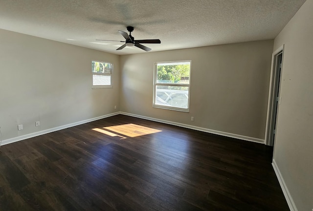 empty room with a textured ceiling, ceiling fan, and dark wood-type flooring